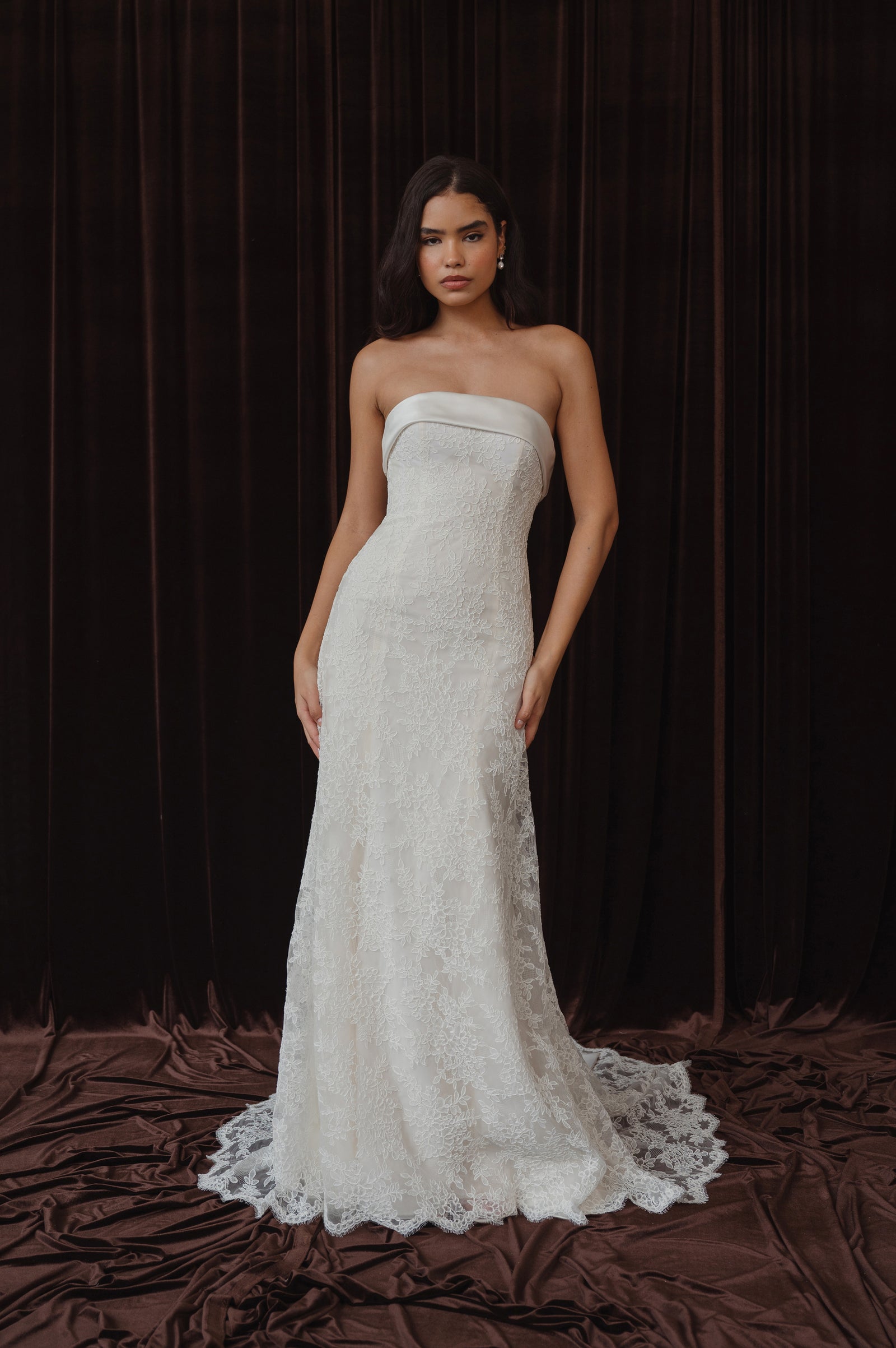 Strapless lace wedding dress with bow back detail on model.