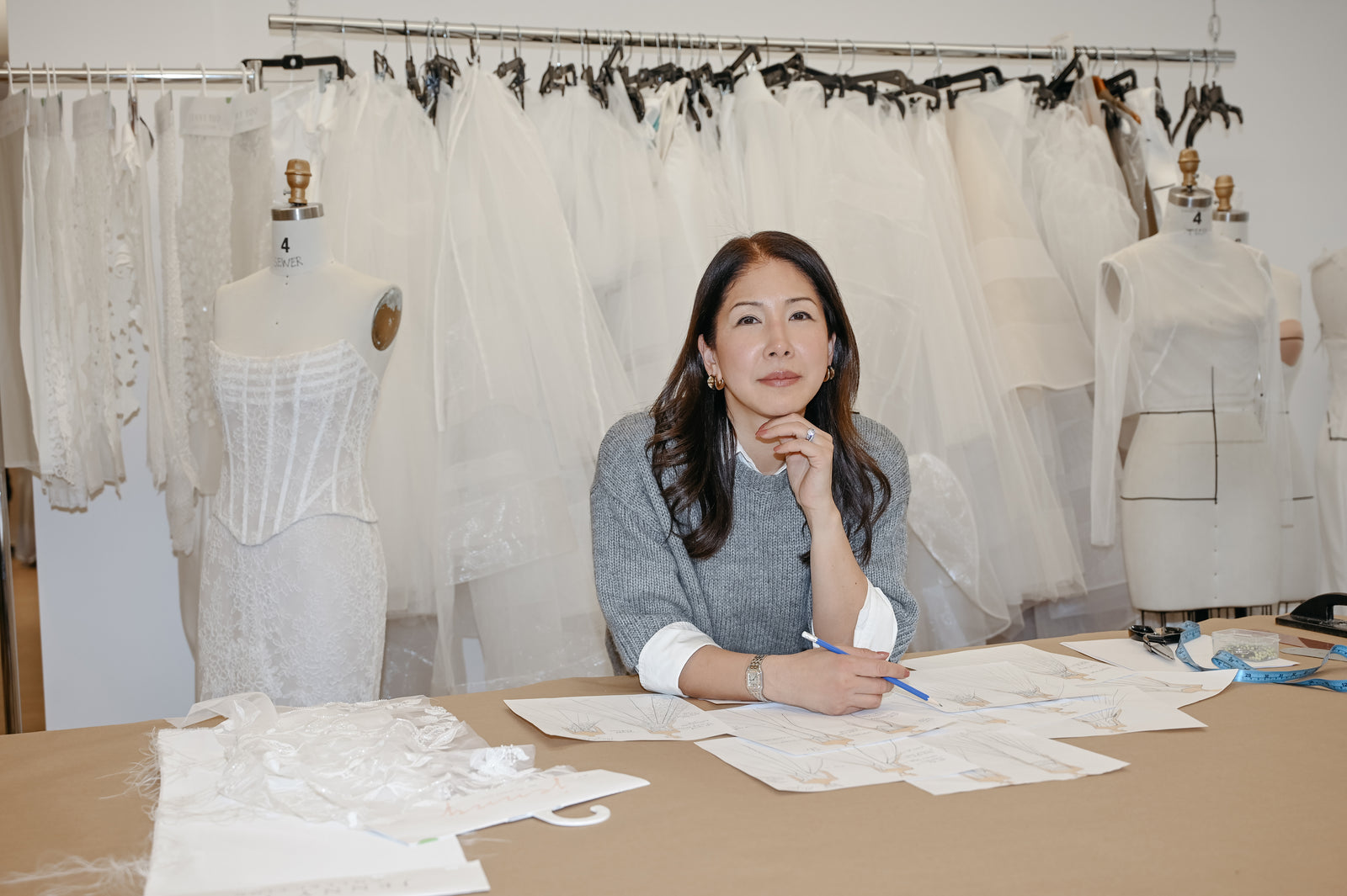 Jenny Yoo in front of wedding dresses.