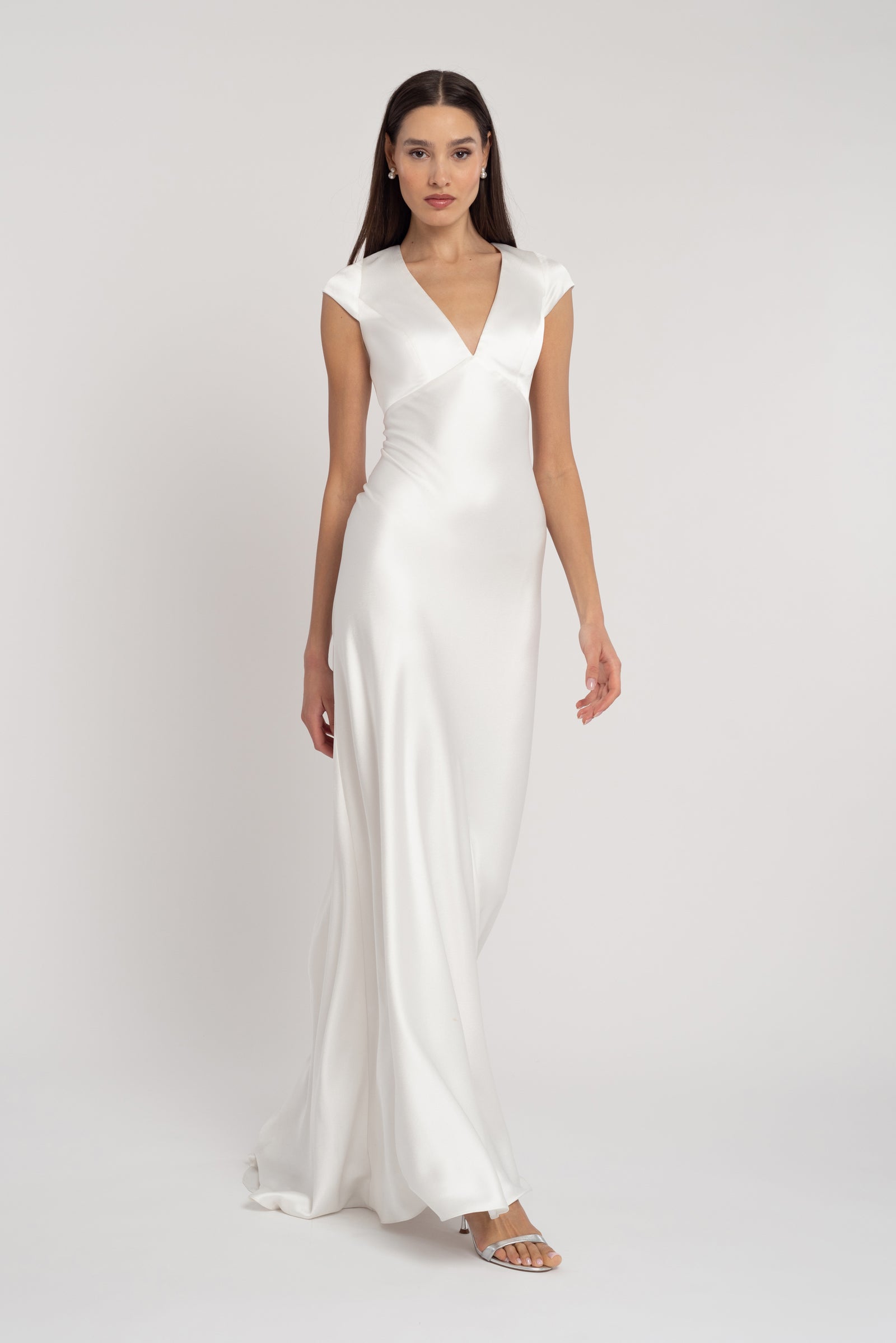 Bronwyn full length bridal gown with subtle v neck and short cap sleeves.