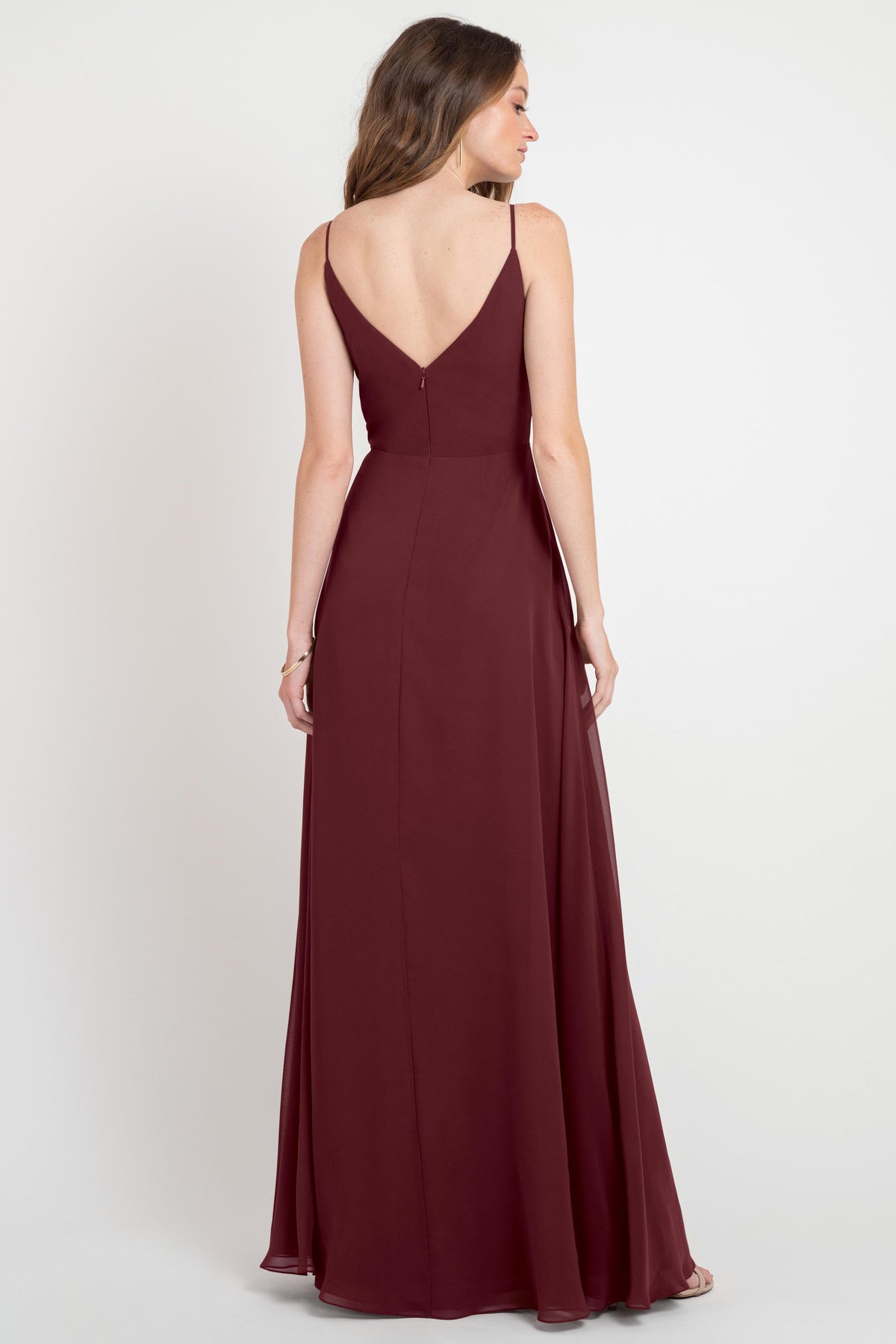 Burgundy evening gown with a deep V-neckline on a white background