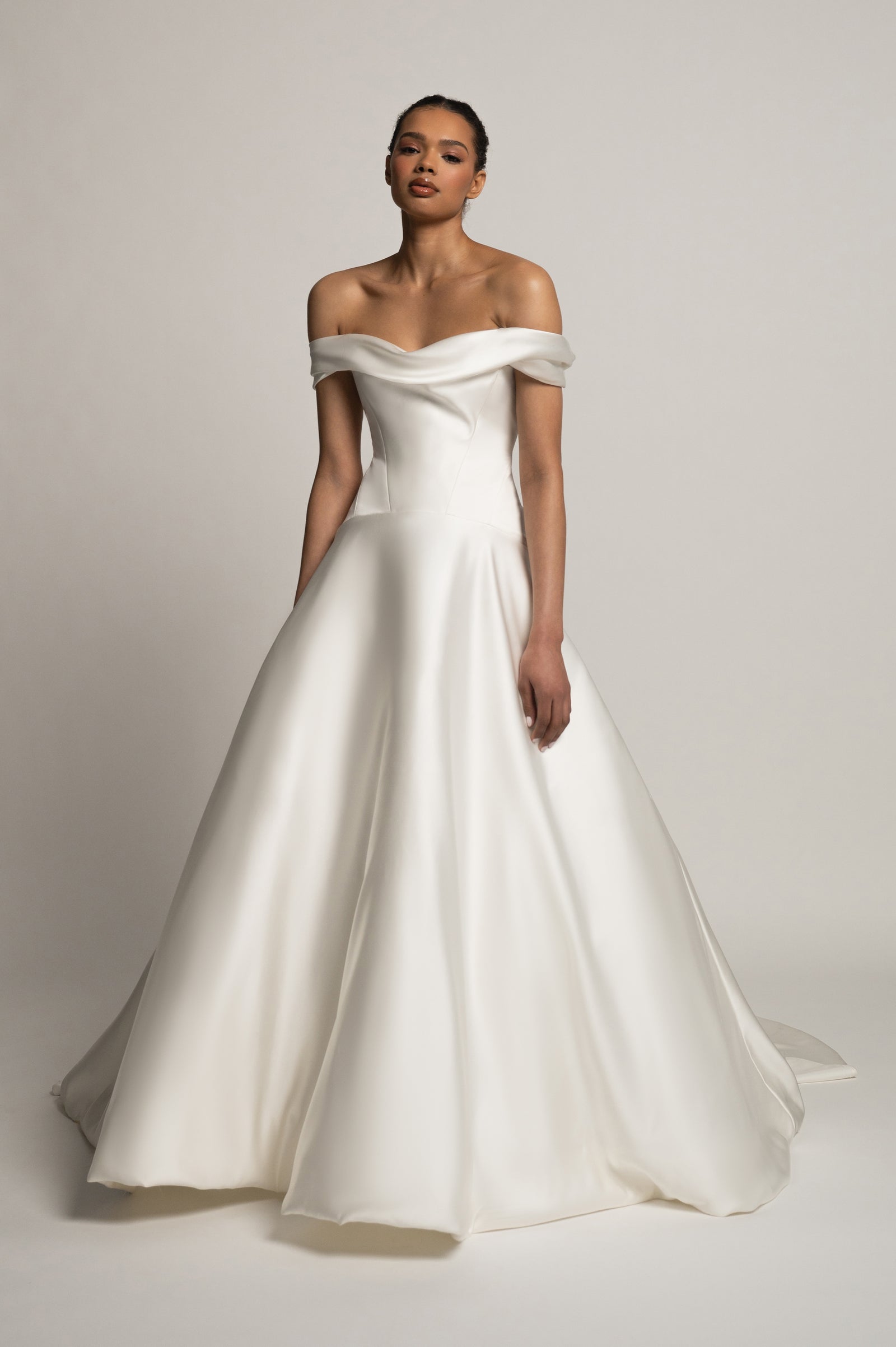 Greer off shoulder A-Line wedding dress with dropped waist on model.