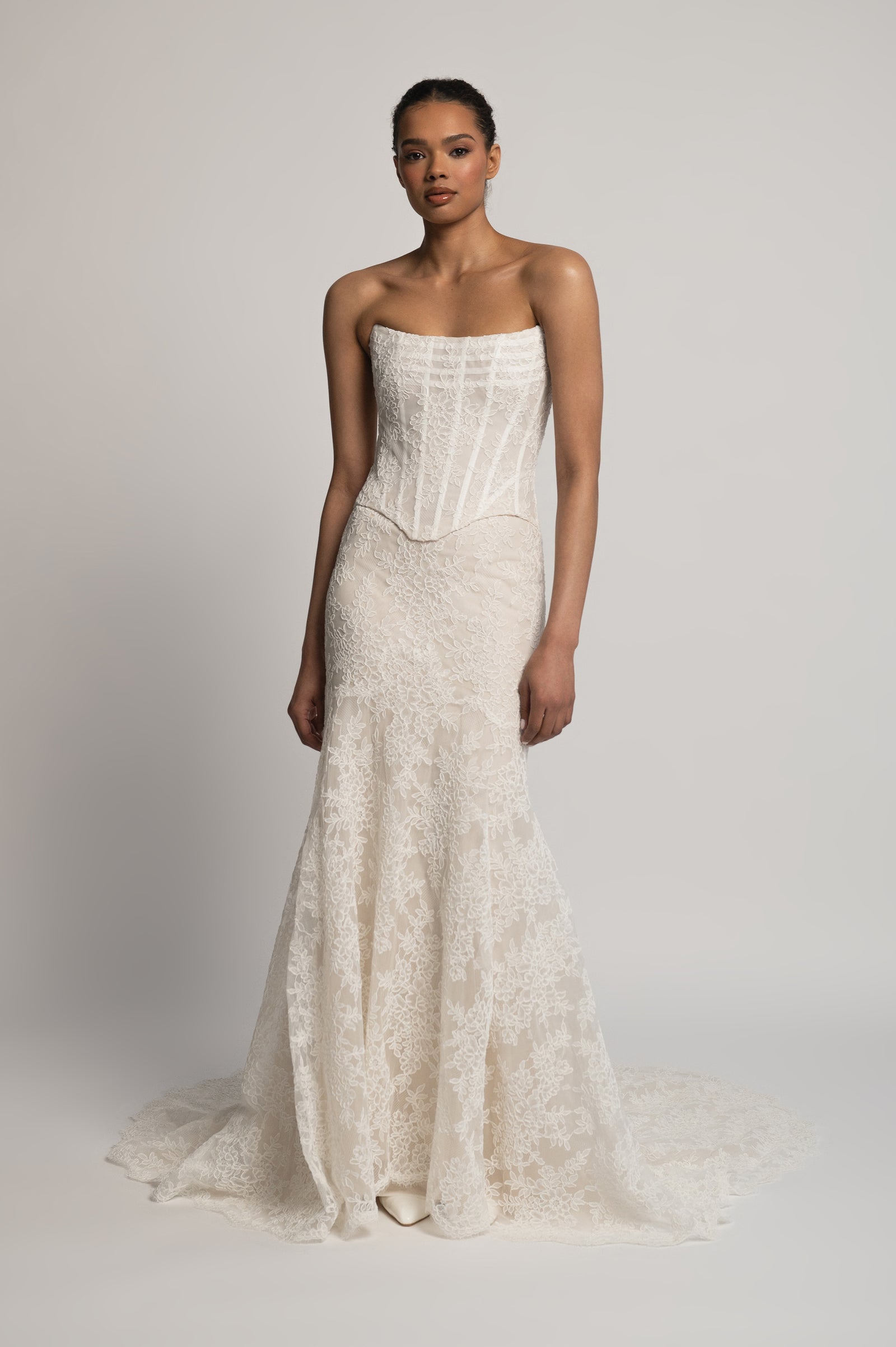 Strapless all lace wedding dress with corseted bodice and fit and flare silhouette.