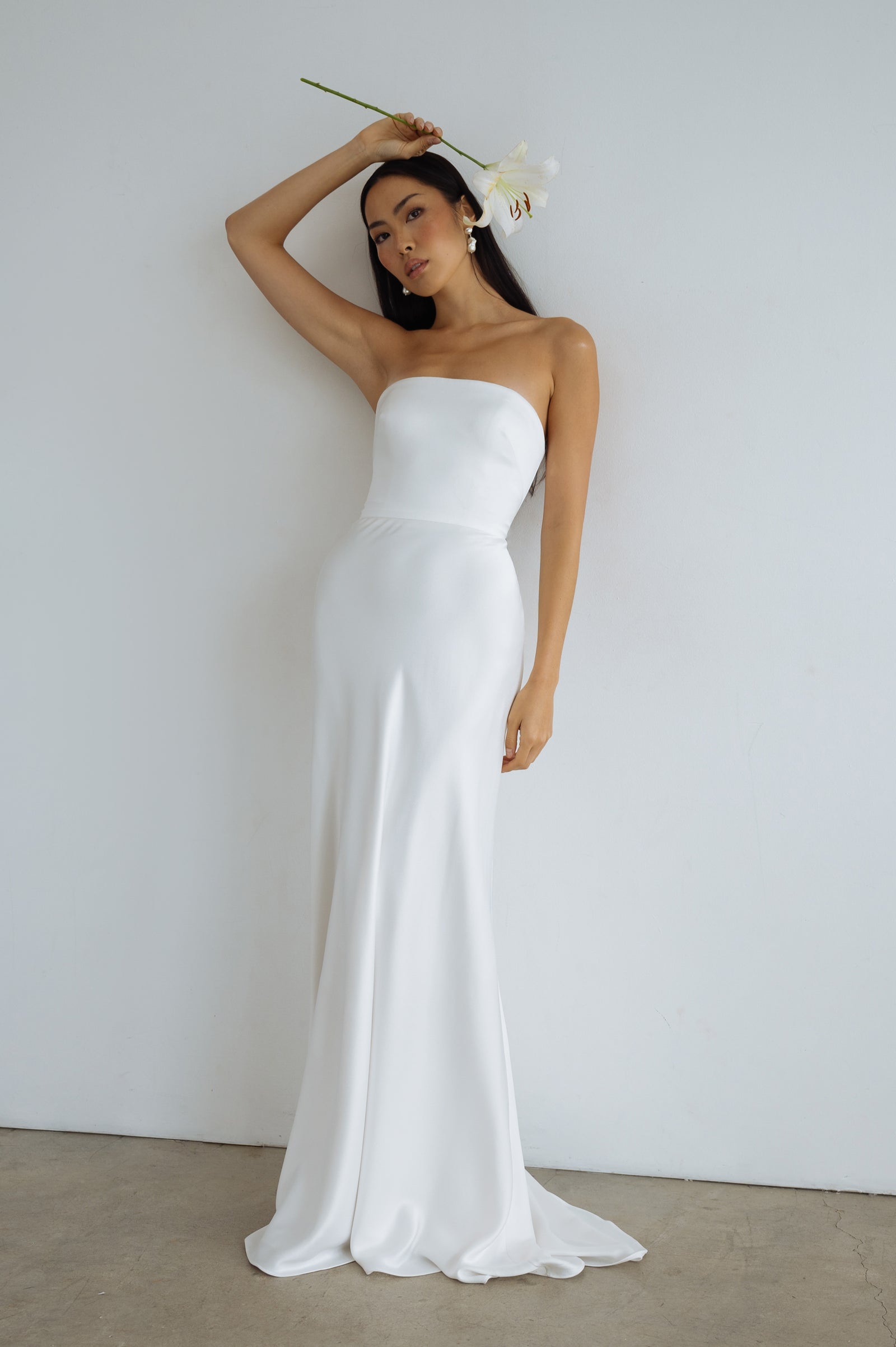 Marion simple minimalist wedding dress with straight strapless neckline and slip skirt.