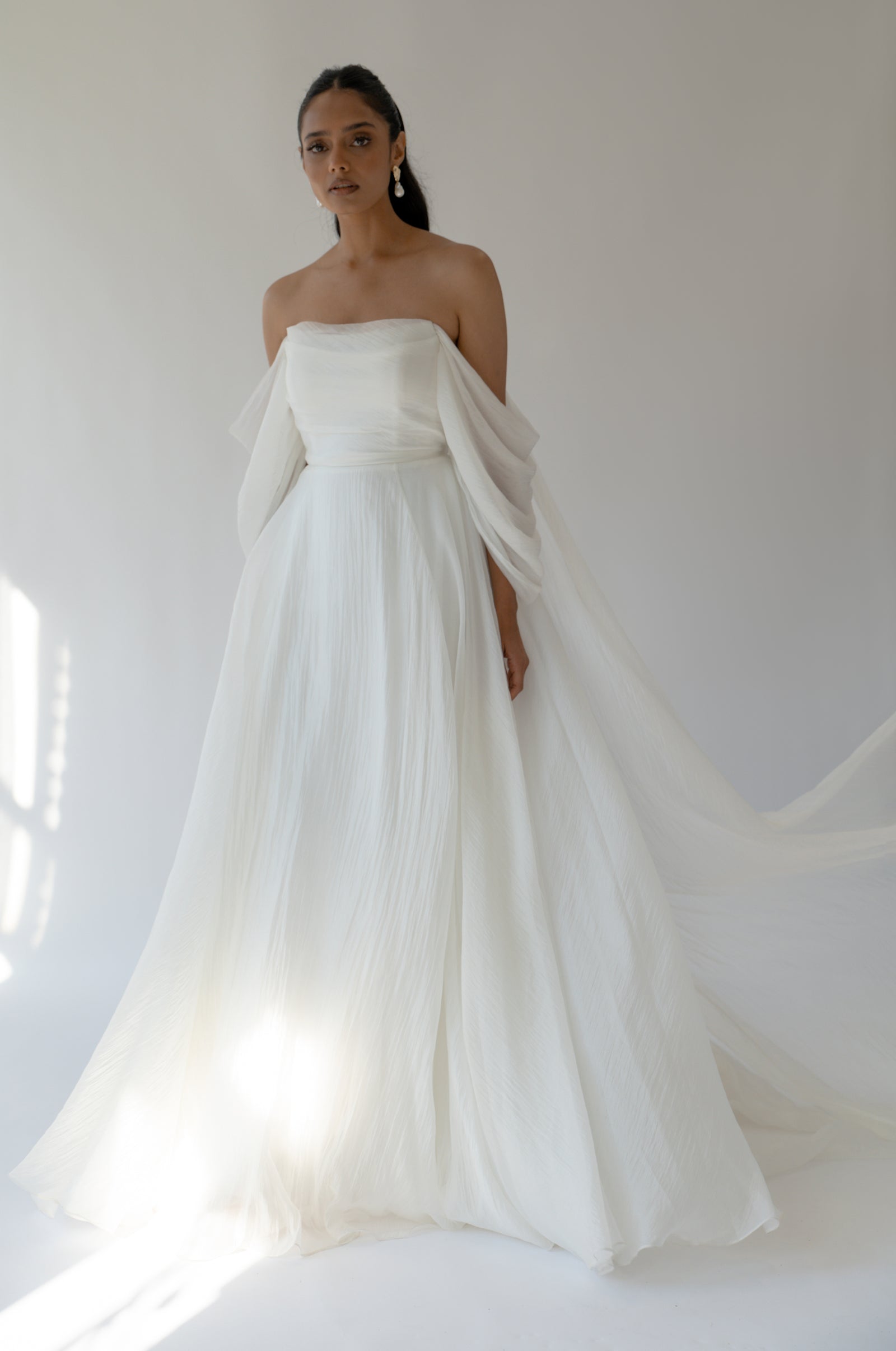 Noa Chiffon A-Line wedding dress with flowing off shoulder sleeves.
