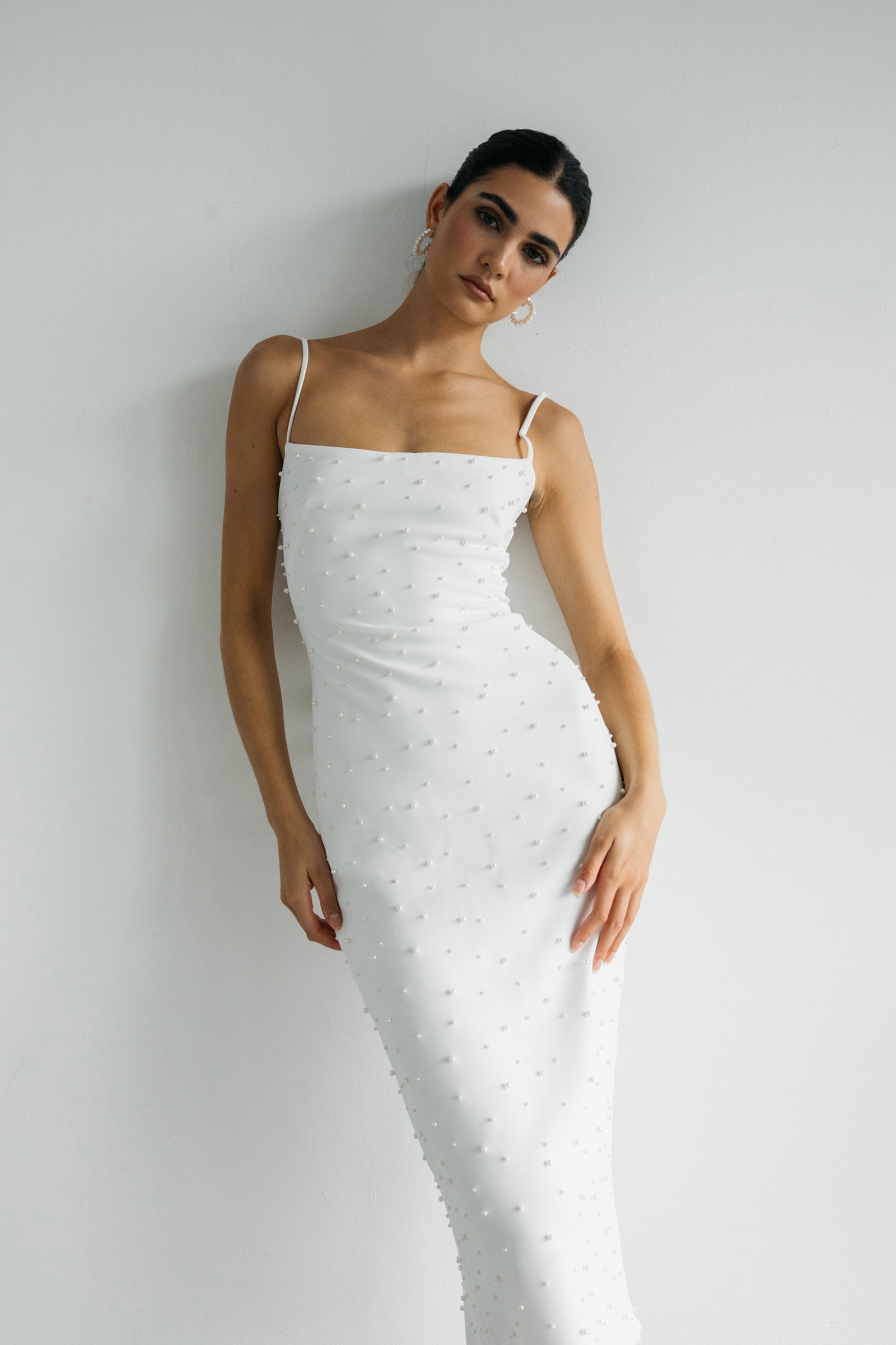 Oksana midi length fitted bridal dress scattered with pearls on model.