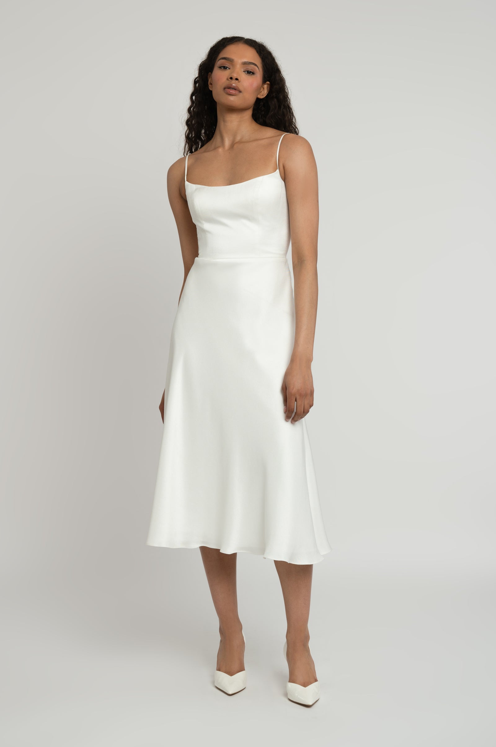 Callie minimalist and simple scoop neck midi bridal event dress on model.