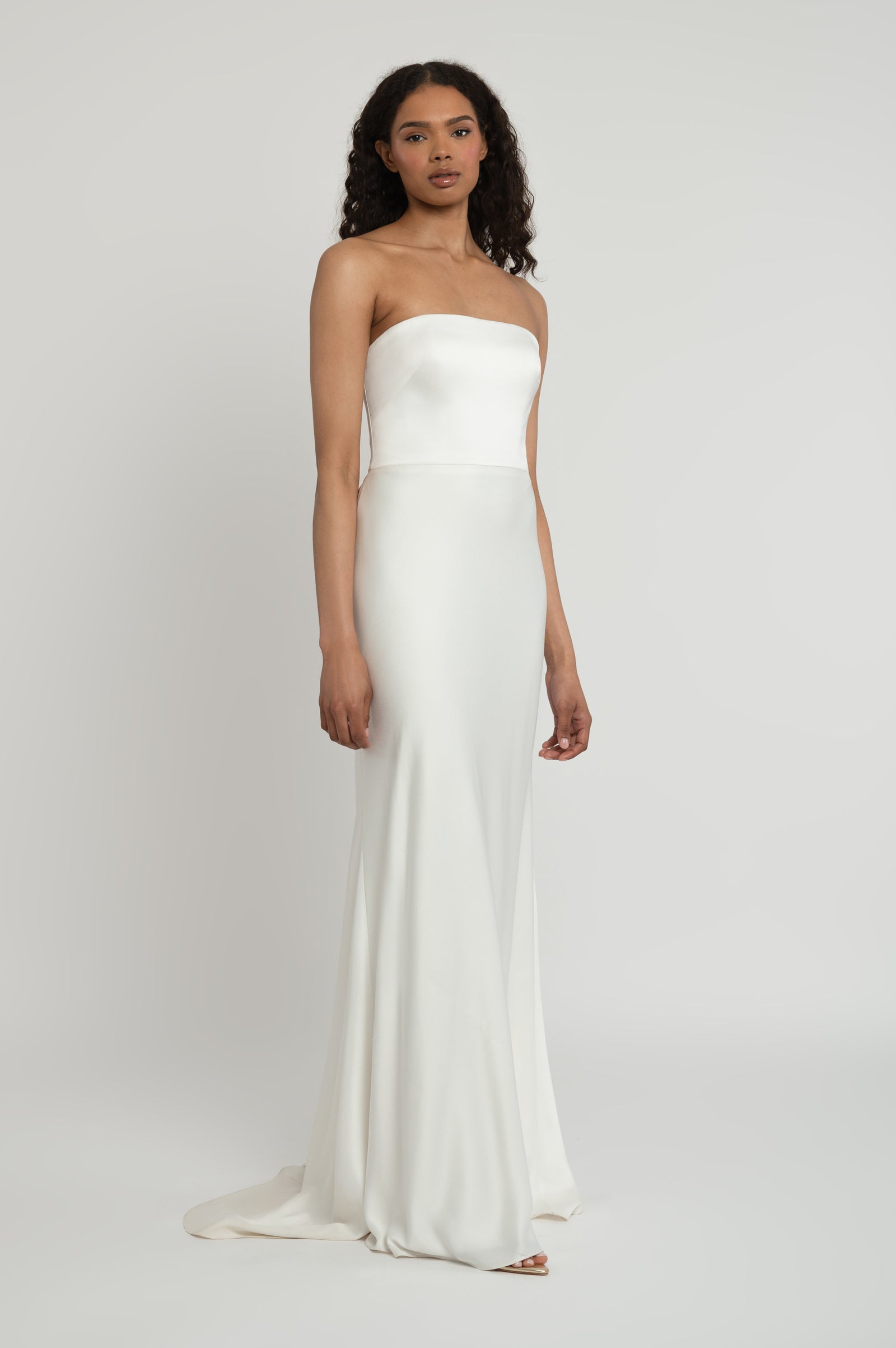 Strapless satin fit and flare bridal gown on model.