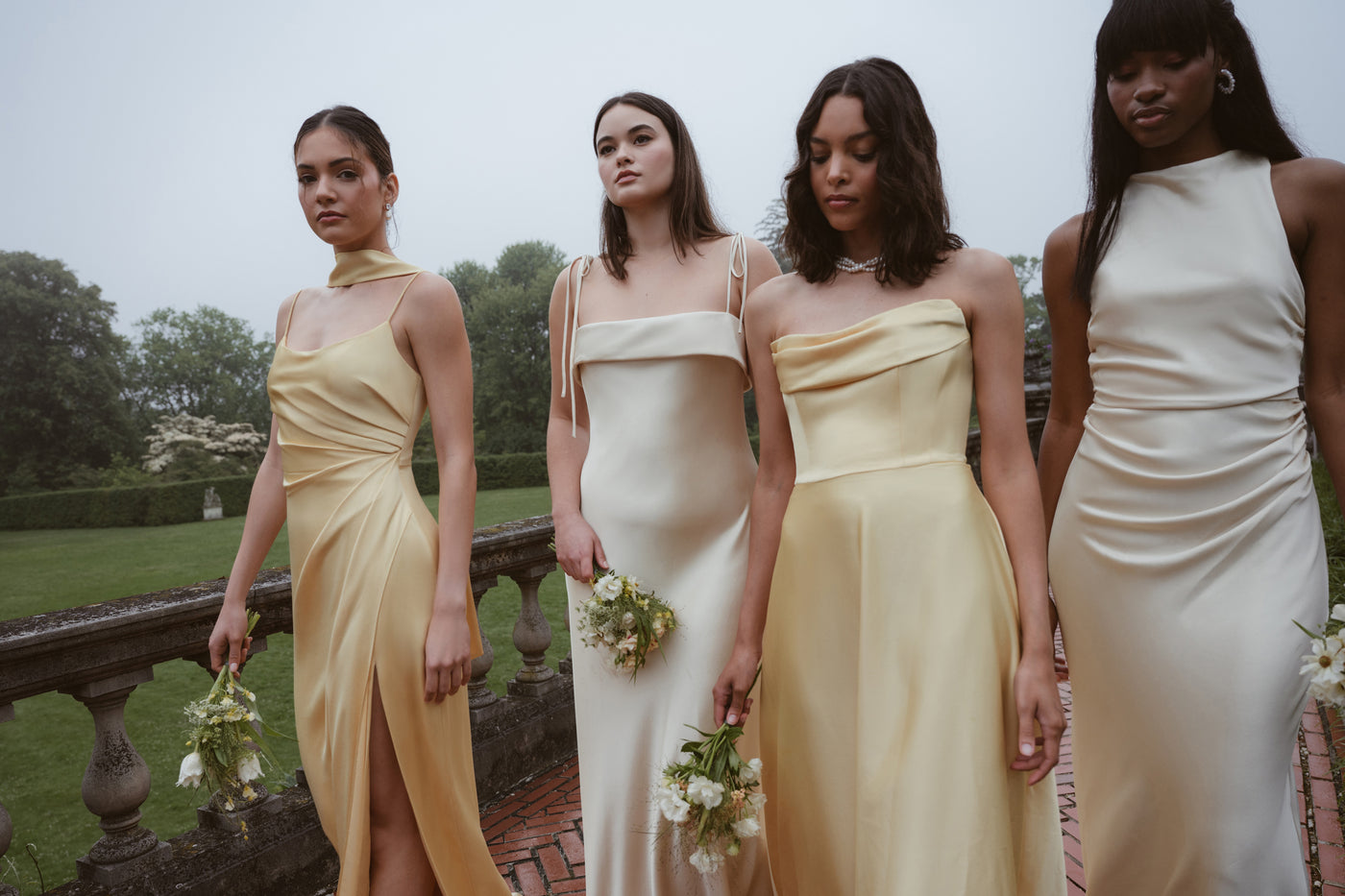 Pale yellow and daffodil satin mismatched bridesmaid dresses outdoor.