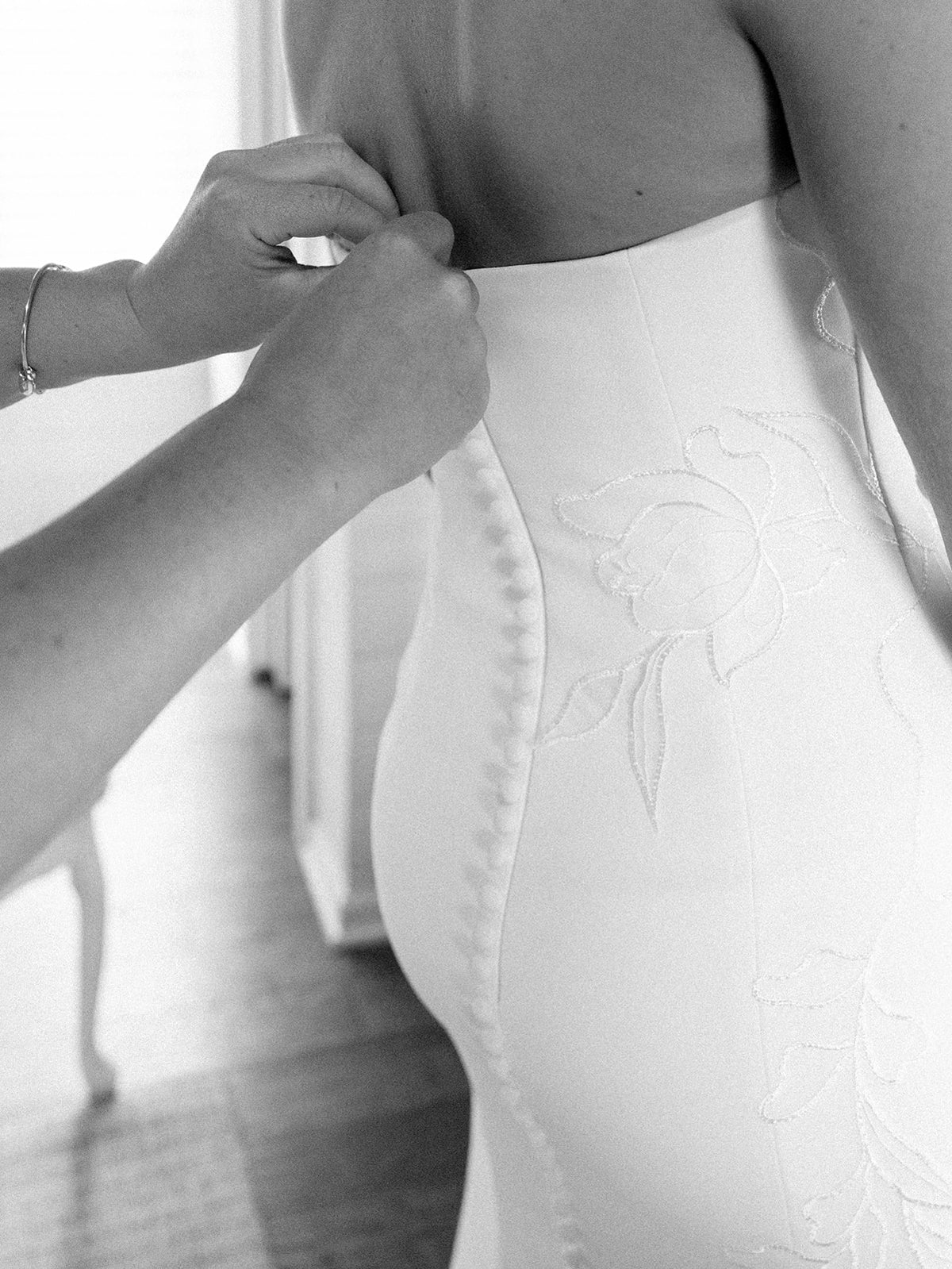 Real Bride Kate in the Timeless Tricia Strapless fit and flare wedding dress with floral applique.