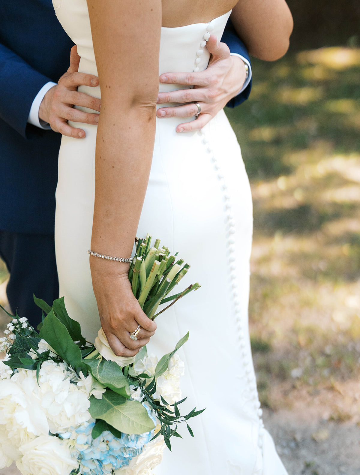 Real Bride Kate in the Timeless Tricia Strapless fit and flare wedding dress with floral applique.