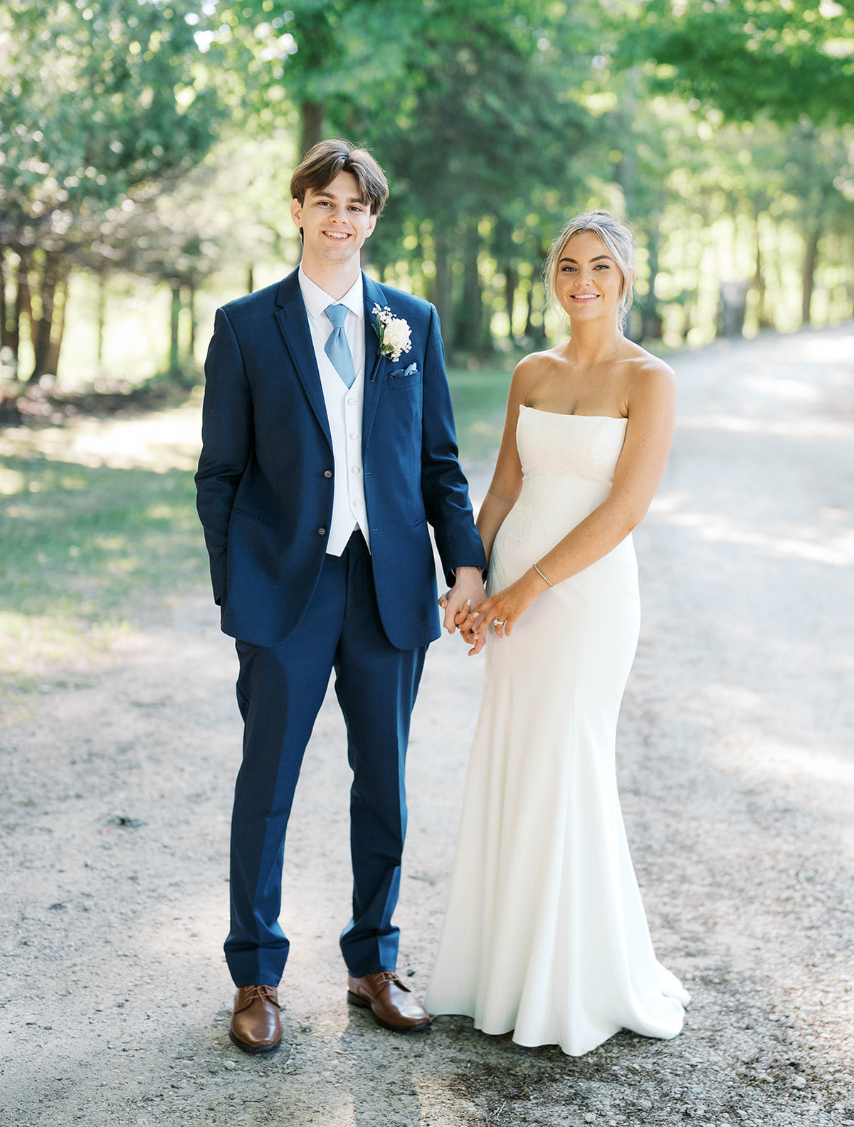 Real Bride Kate in the Timeless Tricia Strapless fit and flare wedding dress with floral applique.