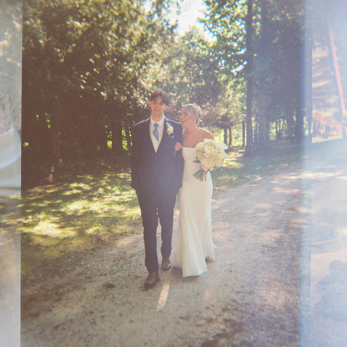 Real Bride Kate in the Timeless Tricia Strapless fit and flare wedding dress with floral applique.