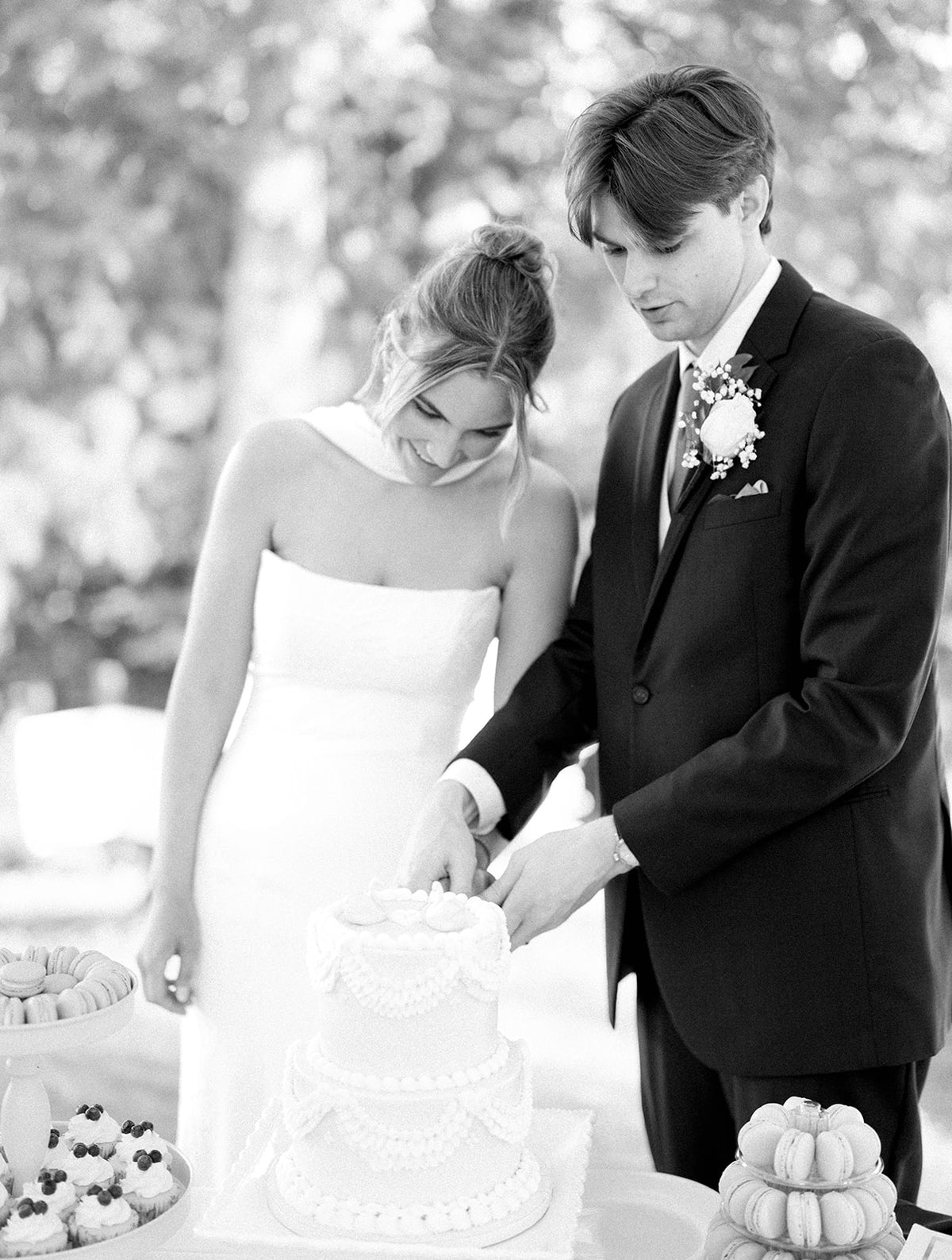 Real Bride Kate in the Timeless Tricia Strapless fit and flare wedding dress with floral applique.