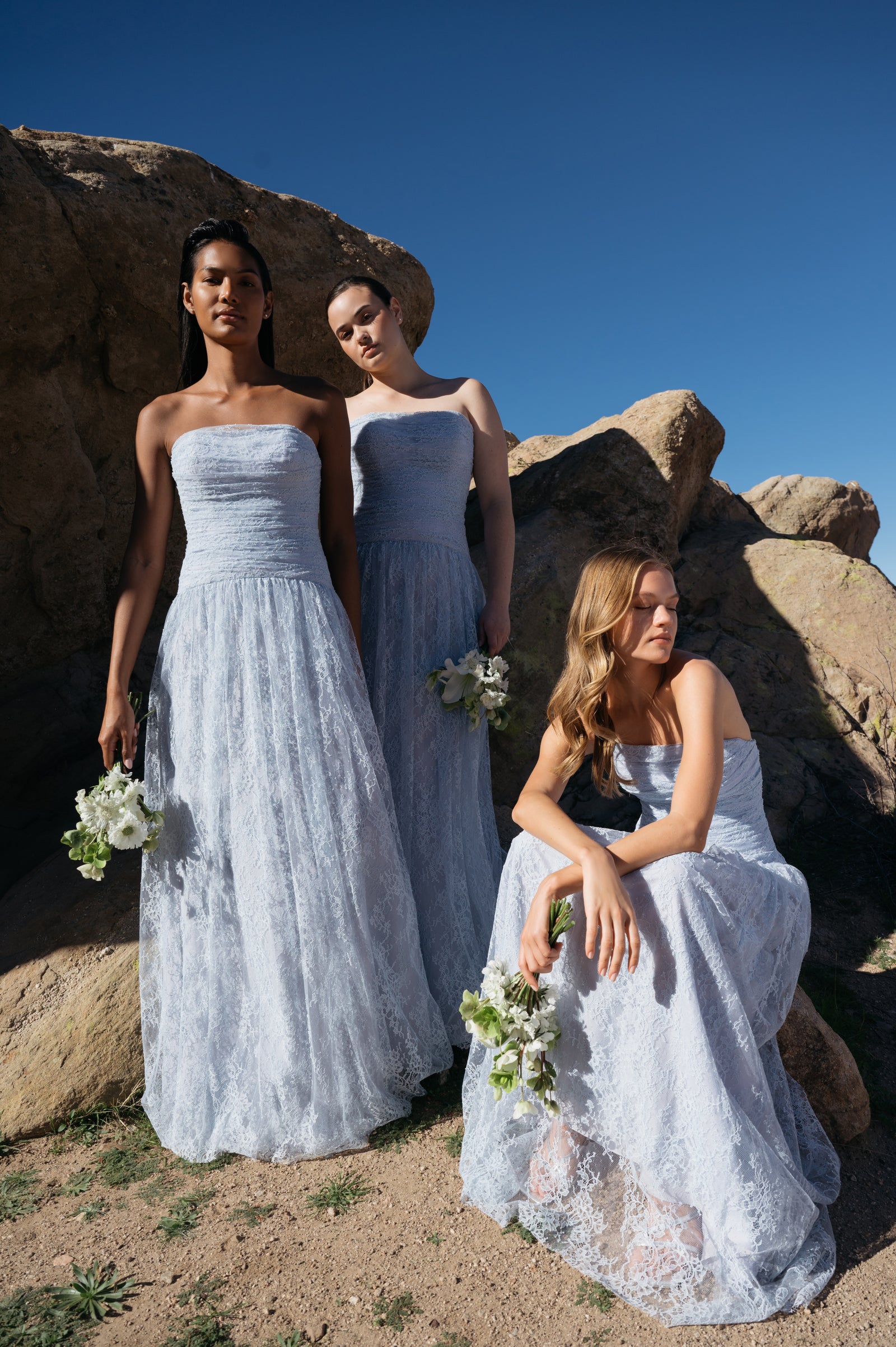 Bridal party wearing Whisper Blue lace bridesmaid dresses.